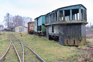 Fototapeta na wymiar Old rusty wagon of the narrow gauge railway. Place of stationing of old steam locomotives.