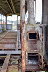 Old rusty wagon of the narrow gauge railway. Place of stationing of old steam locomotives.