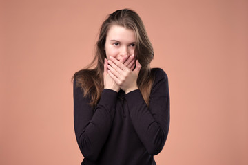 Oops. Surprised young european woman covering mouth with hands