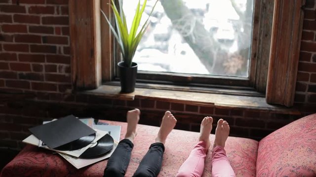 Closeup Of Bare Feet Swaying to Music, Next To A Pile Of Records
