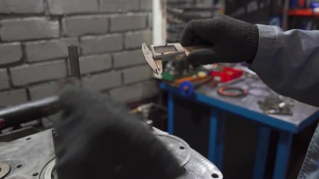 a man measures an electronic caliper washers