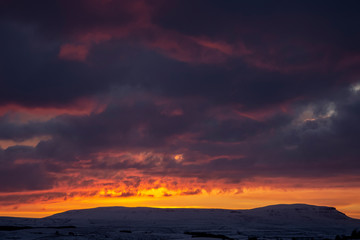 Fototapeta na wymiar sunrise over penyghent covered in snow