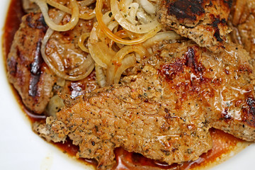 Fried meat with onions in a bowl