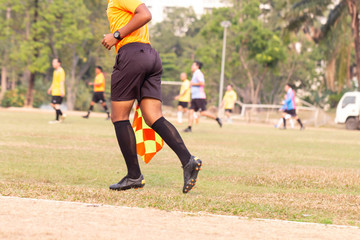 Obraz premium Linesman director running during soccer football game in rural Thailand.