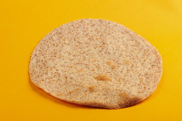 Toasted tortilla on yellow background