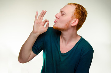 playful, cheerful, red haired man show gesture perfecto. caucasian male gourmet like tasty...