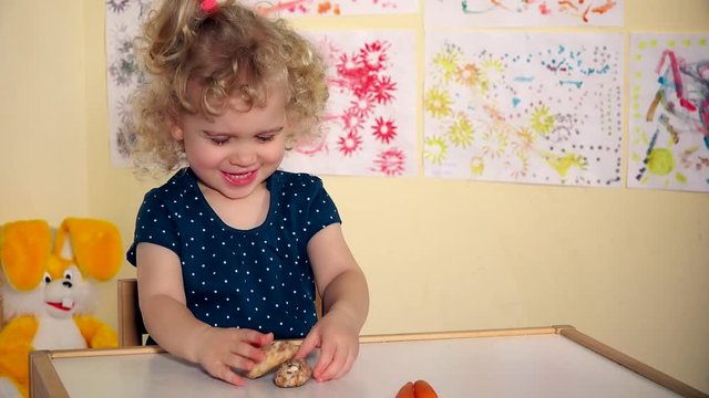 Little kid choose honey cakes not carrots and eat them