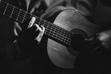 Fototapeta na wymiar Close Up on Man Playin A Guitar, black and white