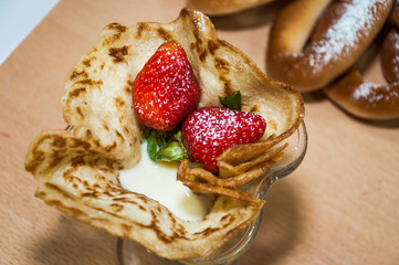 A variety of original pancakes with strawberries and condensed milk in the contest during the celebration Russian Shrovetide (pancake week) at school