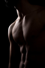 Fit male body on black background