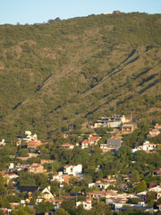 Fototapeta na wymiar A neighborhood on the mountain slope in Villa Carlos Paz, Cordoba, Argentina