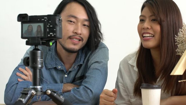 asian couple blogger love on social media with good story to camera home background