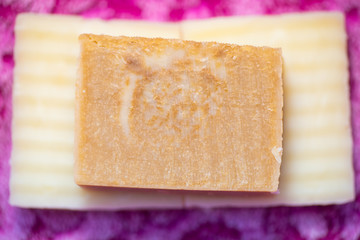 Bars of hand crafted soap on a pink cloth.