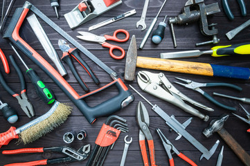 Background from various tools on wooden workbench. top view