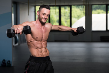 Man With Dumbbells Exercising Shoulders
