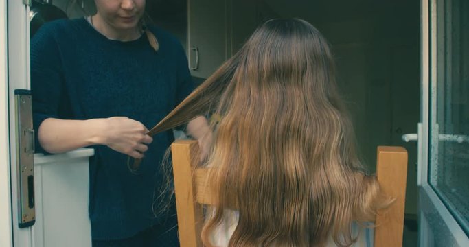 Young woman cutting friends hair