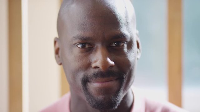 Portrait of handsome black male looking to camera and smiling