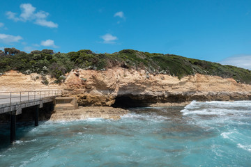 Fototapeta na wymiar Ocean water around a rock cliff and cave.