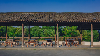 Chairs and tables in covered walkway in the old town of Wuzhen, Zhejiang, China