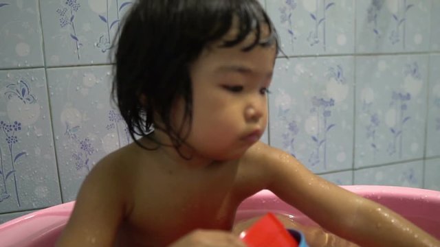 Little asian girl take a bath in the bathroom,Thailand people