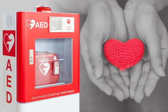 AED or Automated External Defibrillator first aid help giving life heart concept