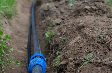 trench with plastic pipe, for water supply in the process of laying construction to the house