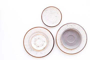 Ceramic plates pattern on white background top view copy space