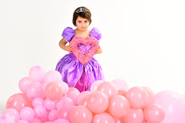 Obraz na płótnie Canvas Childrens day. Valentines day. Small child hold heart. Kid fashion. Little miss in beautiful dress. Childhood happiness. Little girl princess. Party balloons. Happy birthday. Love is a great feeling.