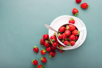 Fresh strawberries in a tea cup, top view