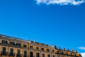 Girona roof cityscape with old building facade on a blue sky