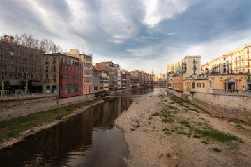 Obraz premium Girona skyline over a wide river with famous landmark cityscape in Catalonia