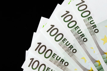 One Hundred euro banknotes on a dark background close up