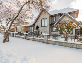A typical american house in winter. Snow covered.