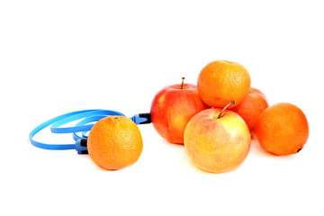 Pyramid from bright orange citrus and red apple connect blue usb charge cable on White background. Isolated. 