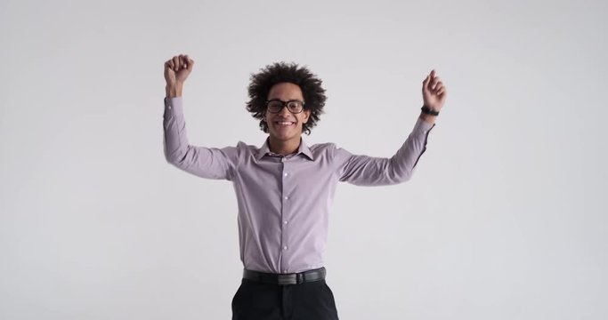Excited businessman celebrating victory over white background