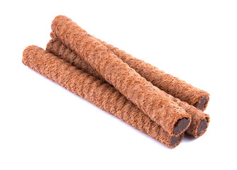 Waffle rolls with chocolate cream on white background