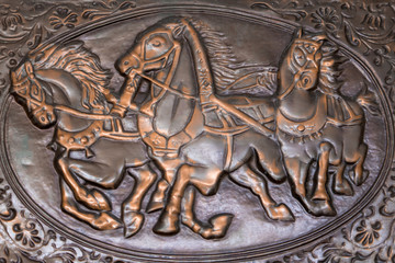 Three horses on a brown background.