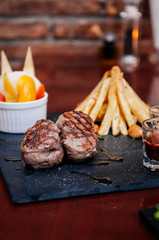 Nice peices of beef tenderloin steak with freach fried potatoes
