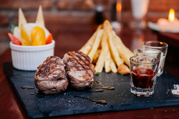 Nice peices of beef tenderloin steak with freach fried potatoes