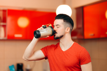 Fototapeta na wymiar Man with Healthy Protein Energy Booster Shake in the Kitchen