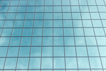 Facade fragment of a modern office building. Exterior of glass wall with abstract texture