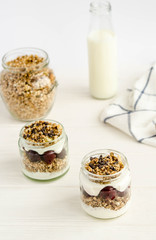 Homemade granola with cherry, yogurt in a glass jar