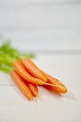 carrots on white wooden background