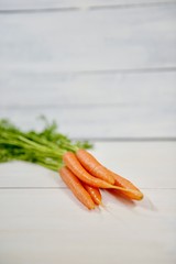 carrots on white wooden background