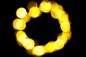 Yellow and white bokeh on a black background. Can be used as a background or wallpaper. Circle shape.