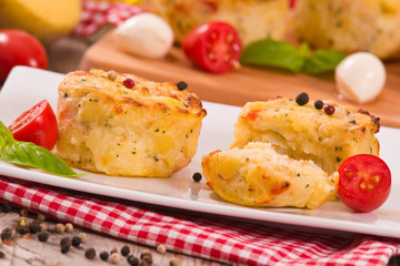 Potato gratins with mozzarella and tomatoes.