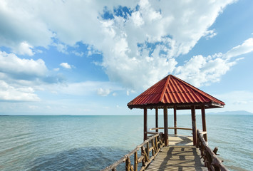 Little pavilion in the sea cloudy background.