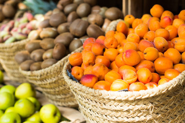 appetizing apricots in wicker baskets on counter in market