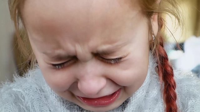 Teen girl cries for resentment. The baby is crying alone.