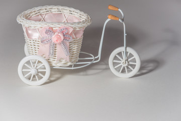 Fototapeta na wymiar decorative bicycle with a basket on a white background